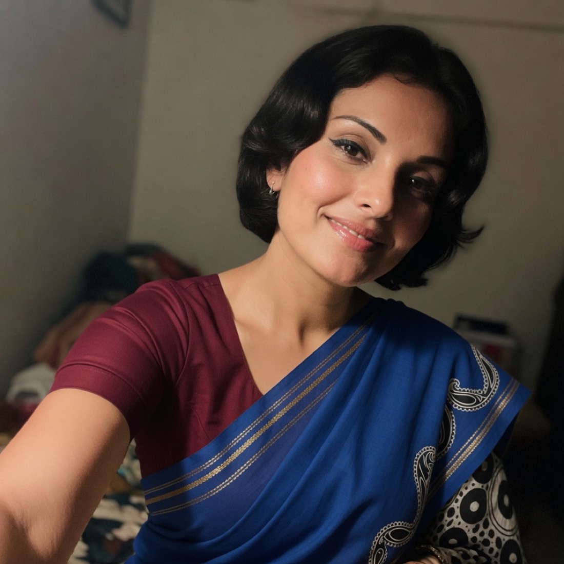 Meera, a phone selfie in a blue saree