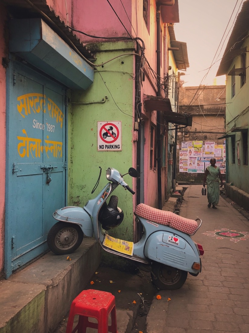 A scooter parked across a narrow lane